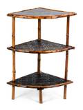 A Victorian Black Lacquered and Bamboo ThreeTiered Corner Etagere